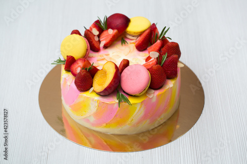 Cake yellow and pink splotches, strawberries, peaches, macaroons, rosemary