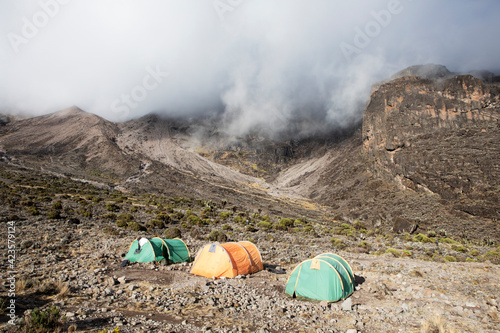 A campsite on Mount Kilimanjaro on a bright day with a hint of fog. © Migara