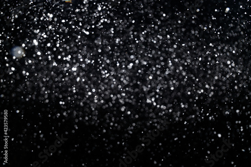 Many snowflakes in blur on black background. Snowfall layer for winter photo © Roman