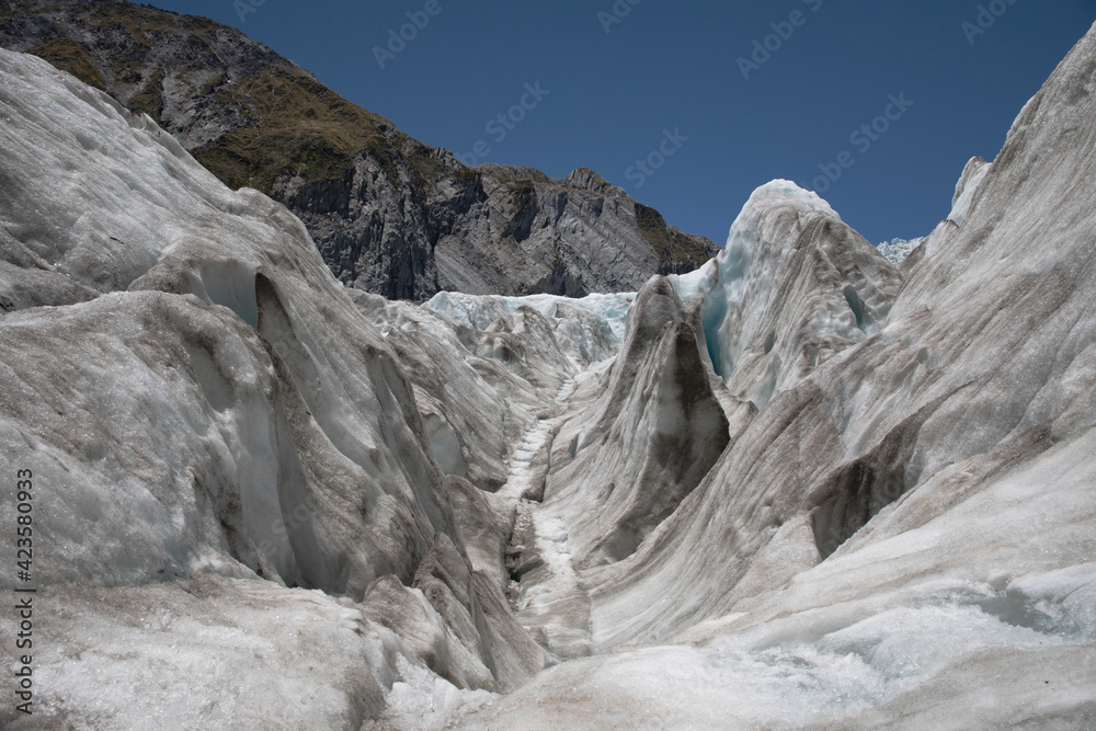 Landscape images from within the Franz Josef glacier showing varying forms of thick ice formations.