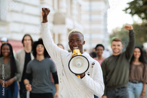 Photos Emotional black guy activist with megaphone on the street