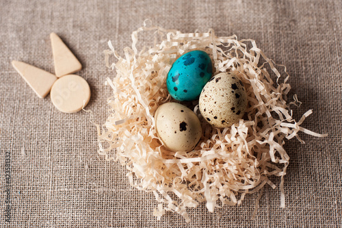 easter eggs in the nest wooden hare icon on a crafting background