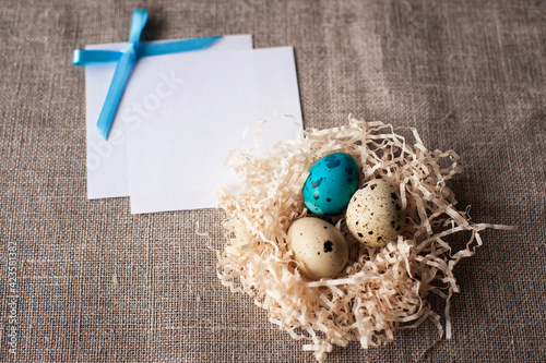 easter eggs in a nest on a crafting background. Space for text