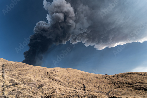 Guy admiring an incredible eruption of the Etna volcano, Sicily