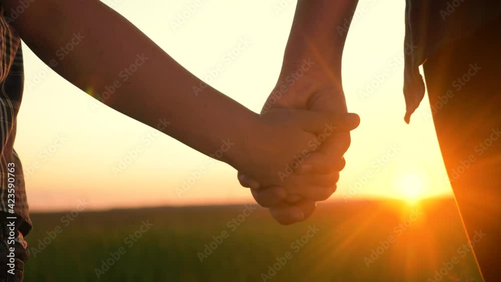 happy family mom and son hold hands close-up teamwork. mother and boy kid together hands at sunset. parent girl and child happy lifestyle childhood. mother day concept