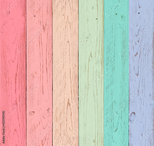 rustic looking wooden boards painted in pastel shades of red, pink, orange, green, blue and violet. background for wedding themes and rustic events in the countryside.