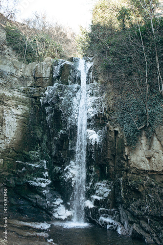 Winter landscape with ice waterfall