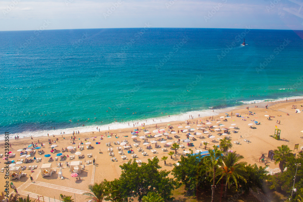 Beach in Alanya, Turkey. View and heights, top view. Blue sea in summer. Vacation in Turkey. Cleopatra beach.