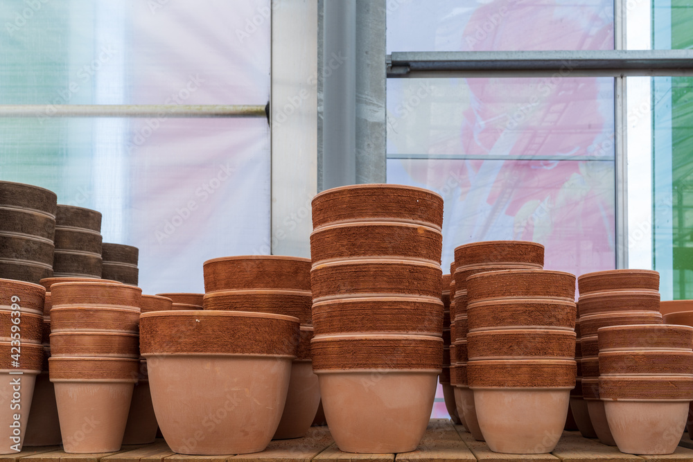 Pots, containers and flower vases on a shelf in a garden center. Pots, containers and flower vases on a shelf in a garden center.