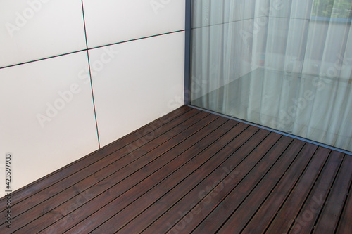 Tableau sur toile Pine wood deck, treated softwood decking terrace contrasting with white facade p