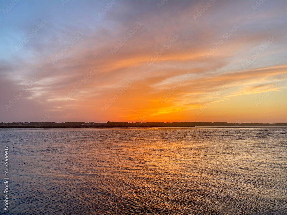 The mouth of the Cavado River at sunset in Esposende, Portugal.