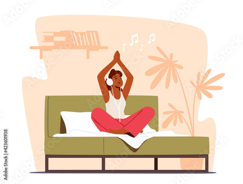 Tranquil Woman Meditating Sit in Lotus Posture with Hands above Head and Headphones on Bed. Morning Yoga Practice