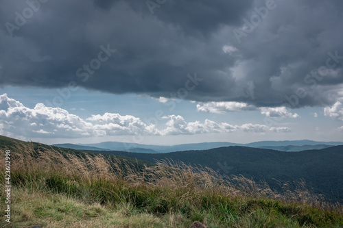 Heavy  dark clouds over the tops of the mountains   windy day  Bieszczady Mountains  Poland