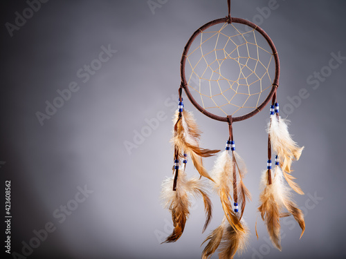 Dreamcatcher on a gray background, with space for an inscription. Cultural Amulet, Indian Culture