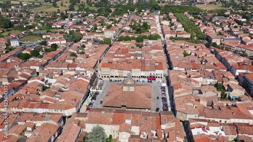 View from drone of houses of Revel town and historic covered market hall at sunny summer day, France 