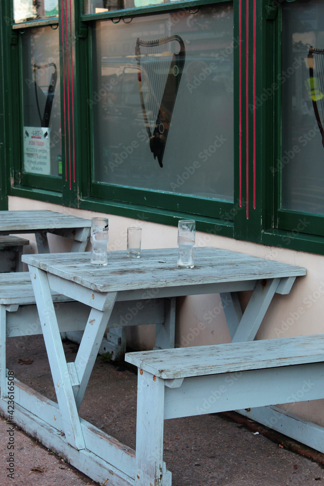 pub pint glasses on an outside table in the street UK pub pint glasses on an outside table in the street UK