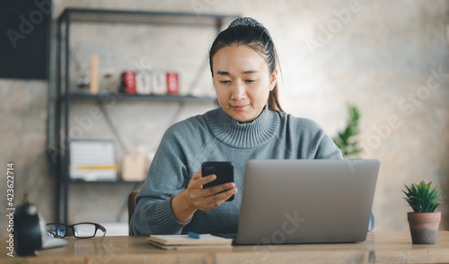 Excited happy Asian woman looking at phone screen, celebrating online win, overjoyed young female screaming with joy, holding smartphone, reading good news in unexpected message or email