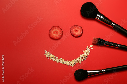 Cosmetic concept. Homemade facial mask of strawberry and oatmeal. Makeup brushes