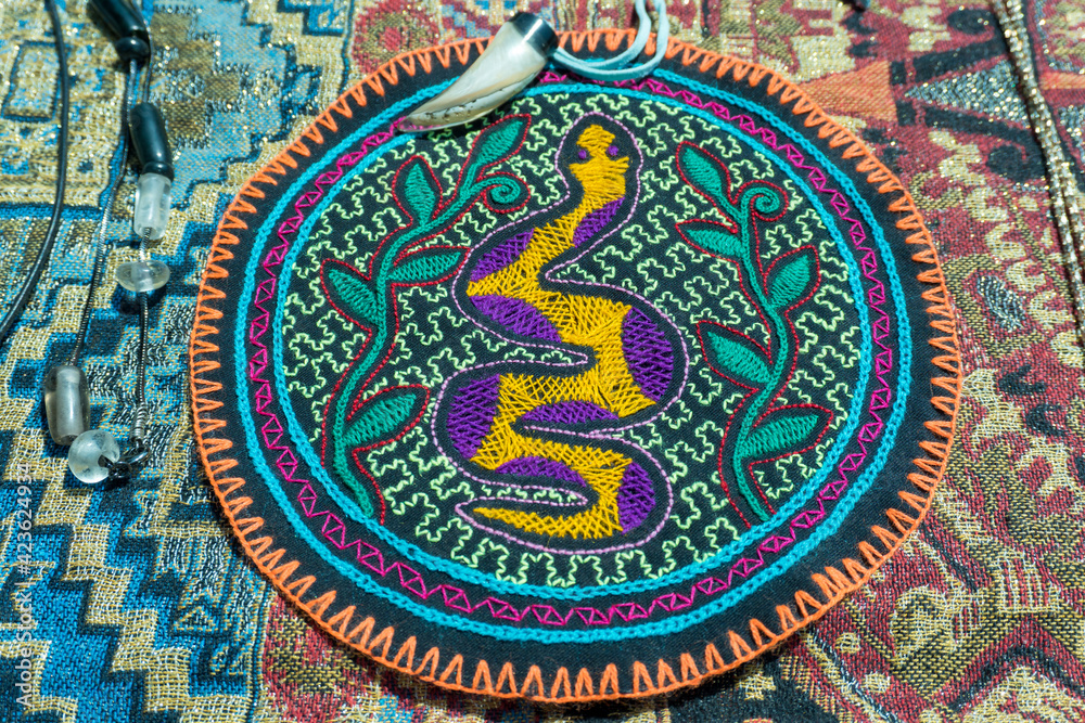 Closeup of old bead necklaces with decorated and sewed cloths for ancient medical rituals