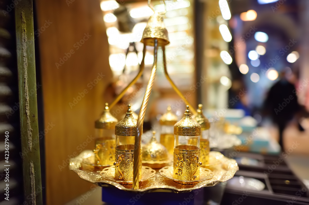 Golden tray with glasses for serve traditional turkish tea in outdoor cafe, Istanbul, Turkey.