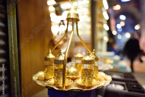 Fototapeta Naklejka Na Ścianę i Meble -  Golden tray with glasses for serve traditional turkish tea in outdoor cafe, Istanbul, Turkey.