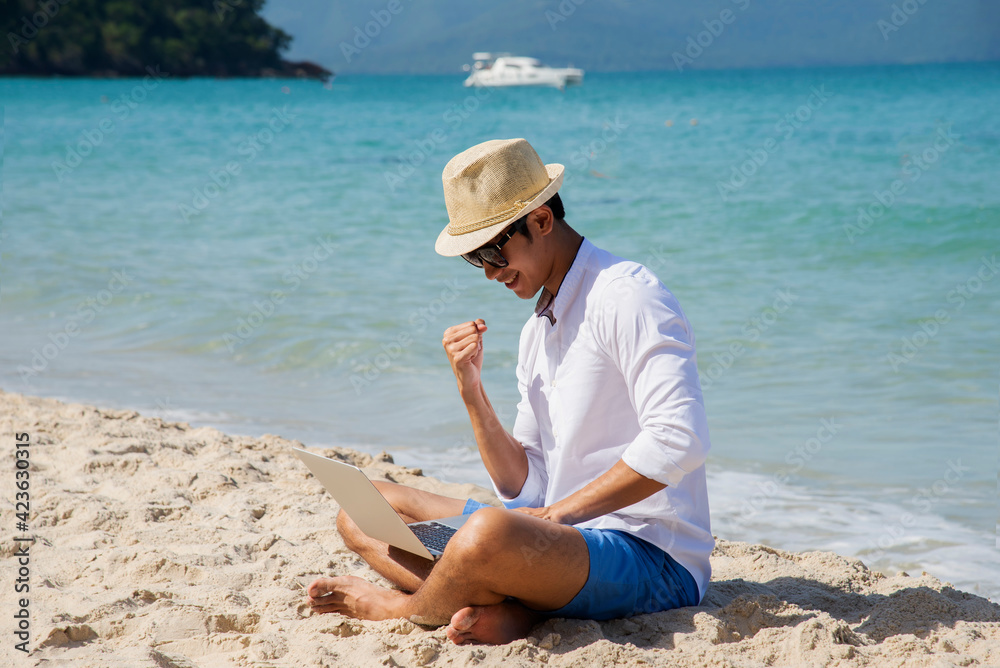 Lifestyle freelance man using laptop working and relax on the beach.  Asia people success and together your work pastime and meeting conference on internet in holiday. Business and Summer Concept