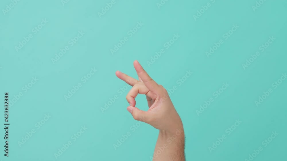 Closeup shot of human hand raising with finger flicking on blue screen