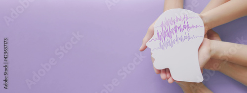 Canvas Print Adult and child hands holding encephalography brain paper cutout, autism, Epilep