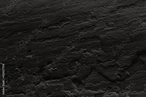 Very black plastered concrete wall.