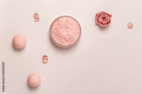 Aromatic crystals of sea salt with essential oil flower of rose. Spa composition with cosmetic bathroom product top view