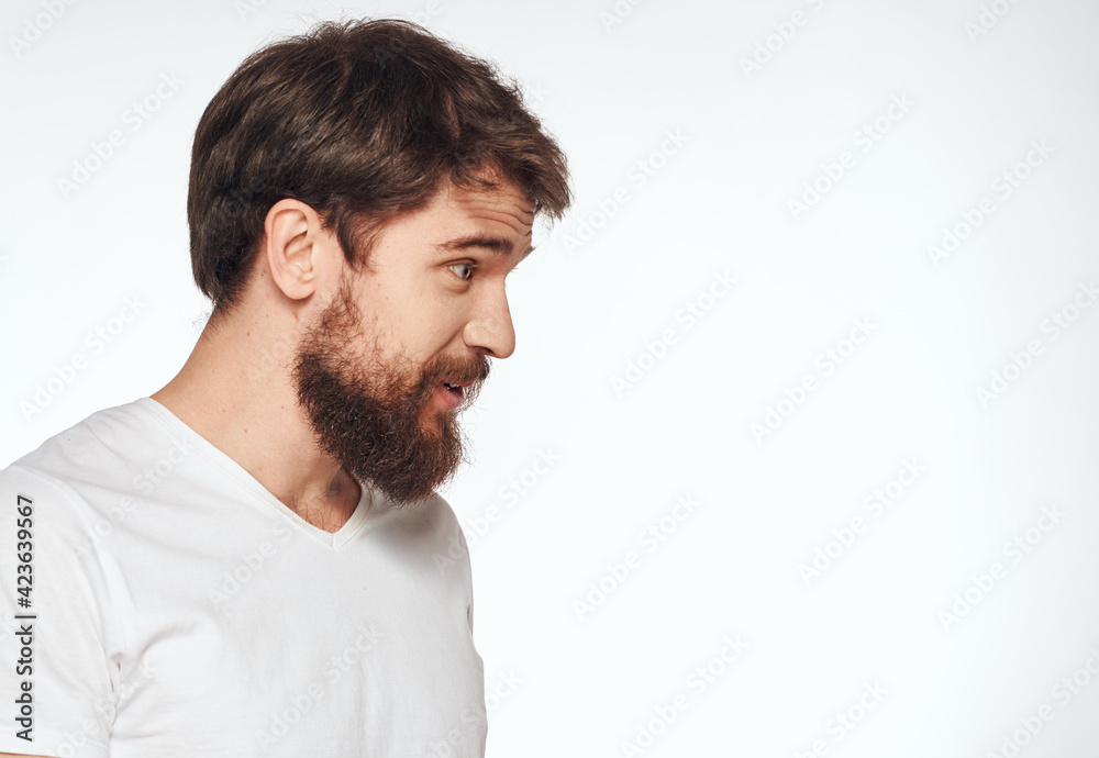 Portrait of a man side view light background white t-shirt model