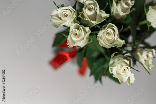 A bouquet of white tea roses on a light table background. Top view. selective focus