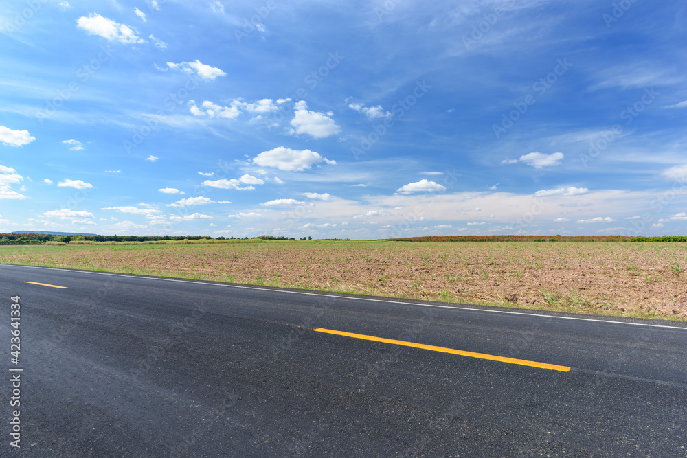 Side view of asphalt road and beautiful blue sky. Side view of asphalt road and beautiful blue sky.