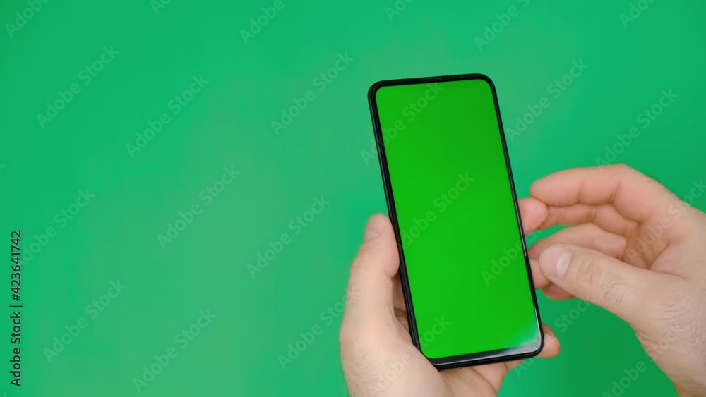 Handheld Camera: Point of View man Holding Chroma Key Green Screen Smartphone Watching Content. Swiping the screen with your finger and tapping the center of the screen Handheld Camera: Point of View man Holding Chroma Key Green Screen Smartphone Watching Content. Swiping the screen with your finger and tapping the center of the screen