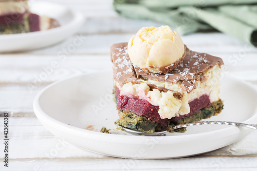 Wallpaper Mural A broken piece of cake on a saucer close-up, without eggs and gluten, with a cream and strawberry layer, on a light wooden table. Torontodigital.ca