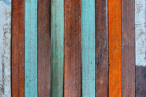 Background or wallpaper of multicolored wooden table board surface. Thin colorful rough boards with knife marks