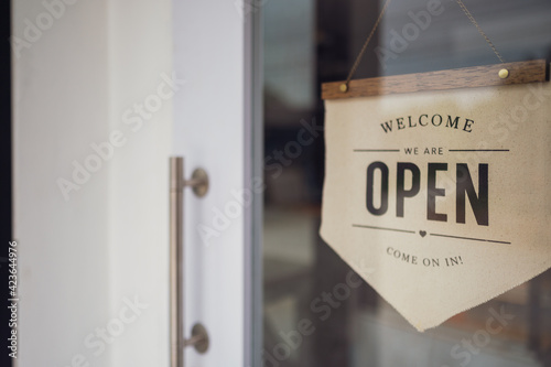 Open Sign at door of Small bossiness.