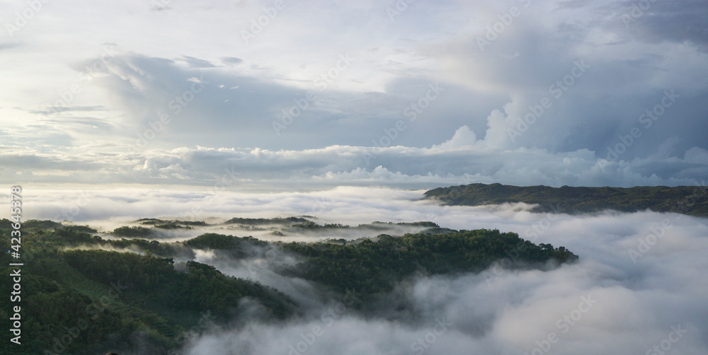 Nature background with fog on mountain. Countryside in early summer. enjoy sunrises and fog-covered mountains.