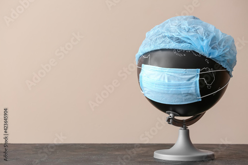 Globe with medical mask on ...