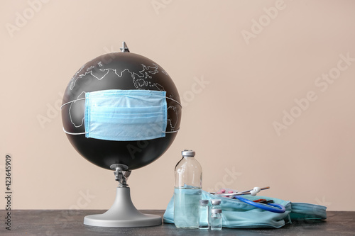 Globe with medical mask and...