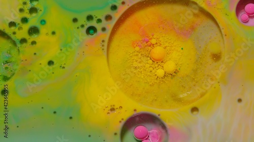 Colorful, gorgeous, vibrant theme or background, cosmetic effect. Bubbles float in liquid paint. Mixing ink, oil and milk. Abstract multicolor hypnotic painting in slow motion. Macro. Pattern, design