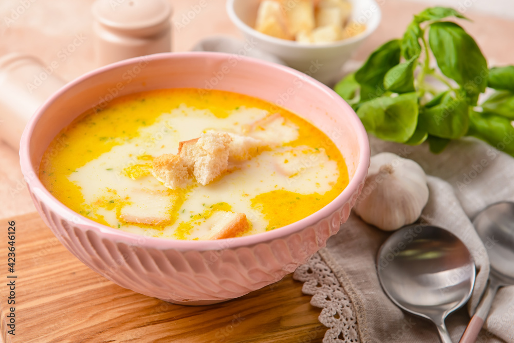 Bowl with tasty garlic cream soup on color background Bowl with tasty garlic cream soup on color background