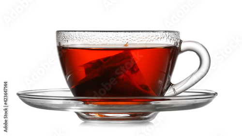 Cup of hot aromatic black tea on white background