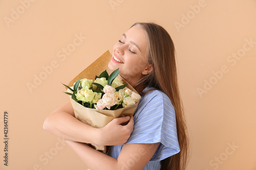 Happy woman hugging bouquet...