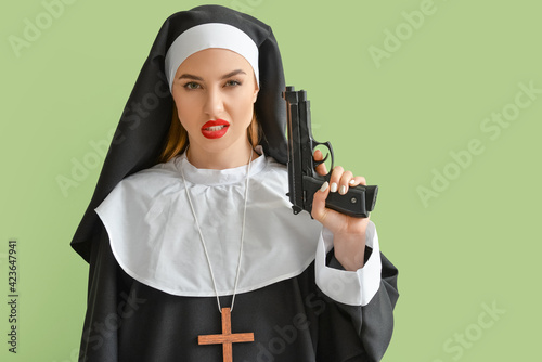 Canvastavla Sexy nun with gun on color background