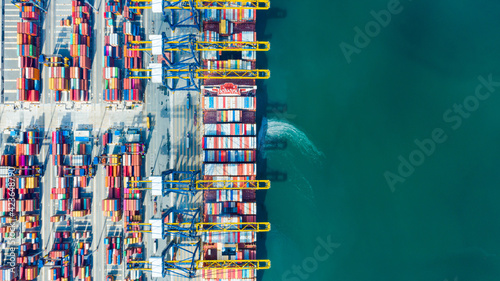 Aerial top view Cargo operations on container ship in port. Business logistic commercial intermodal freight transport in import export, Cargo ship of international at seaports in the world