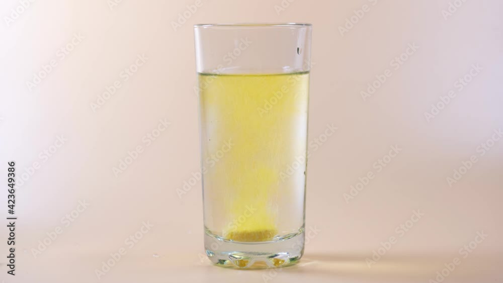 Close up of glass of water and a water soluble vitamins. Close up of glass of water and a water soluble vitamins.