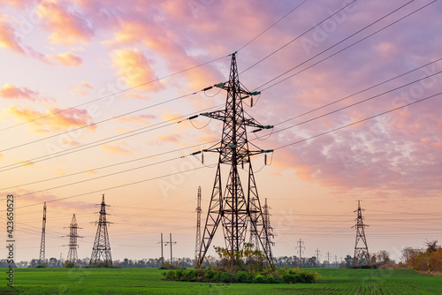 Power lines against sunset sky