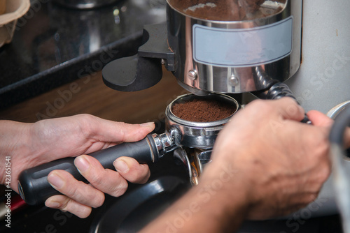barista blending coffee bean prepare for making espresso shot