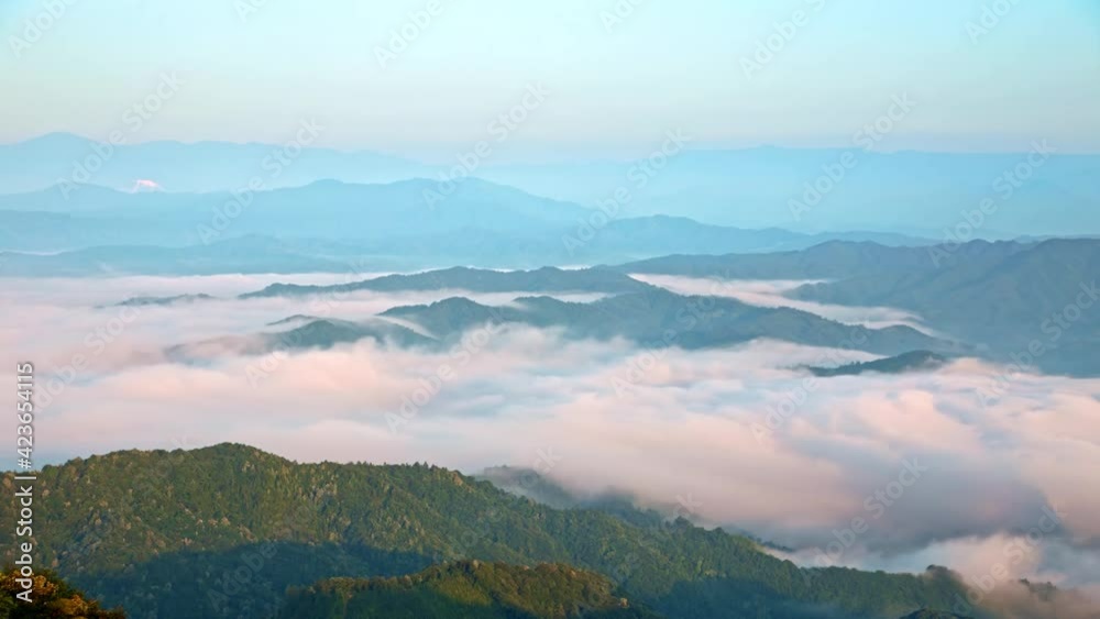 Time-lapse of the sea of clouds with fog flowing on the top of green mountains Time-lapse of the sea of clouds with fog flowing on the top of green mountains